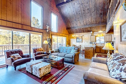 Gather in the open great room beneath soaring wood ceilings