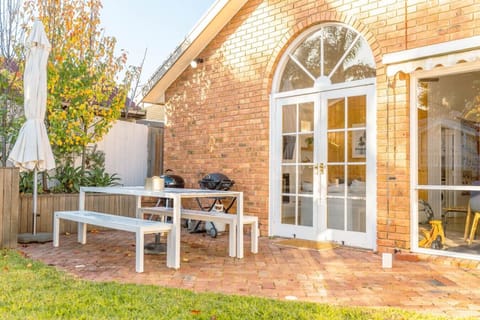 Charming brick courtyard with BBQ and autumn garden views