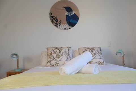 Drift into a restful sleep on a plush queen bed featuring high-quality linen, soft pillows, and a su