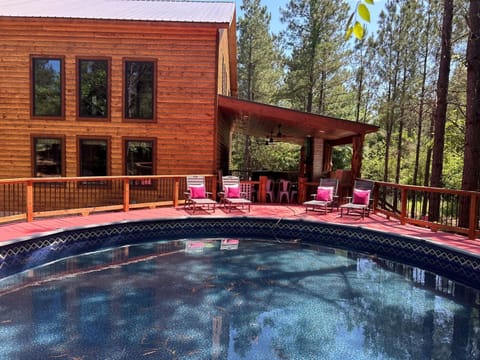 Dive into your private pool oasis, then unwind on the spacious deck with forest views and a covered lounge area for relaxation.