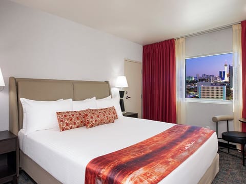 Wake up to skyline views from a plush king bed.