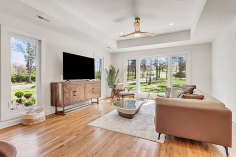 Bright front living room with abundant natural light and Smart TV.
