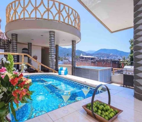 Roof/Garden/Pool  terrace with heated dipping pool , lounge, kitchen , gas grill , sundeck and entrance to pool banjo and separate LOVERS roof suite .  mountain , city , hotel zone view. New Gazebo added atop high platform seen in the photo.