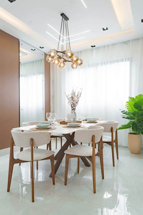 Beautiful modern dining area for 6 guests, designed with elegant finishes, designer lighting, and a bright open-concept feel.