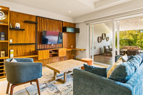 Relax in a beautifully designed living space featuring modern furnishings, warm wood accents, and seamless indoor-outdoor living.