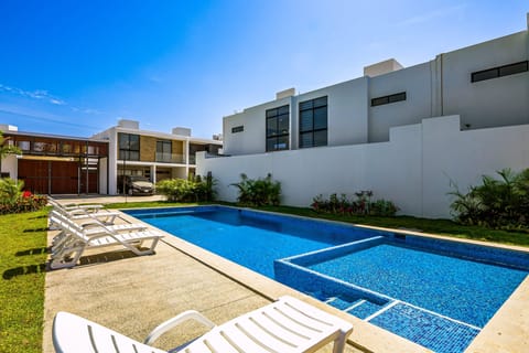 Enjoy your own refreshing private pool with lounge chairs and a spacious outdoor area perfect for sunny afternoons.