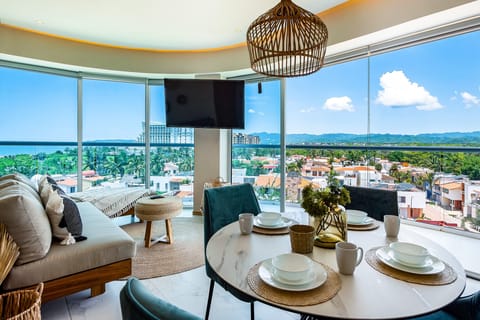 Stunning corner unit with floor-to-ceiling windows showcasing breathtaking ocean, city, and mountain views.