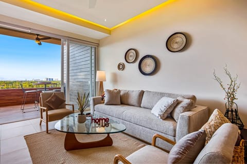 Relax in the stylish living room featuring comfortable seating, modern décor, and seamless access to the terrace, creating a bright and inviting space to gather.