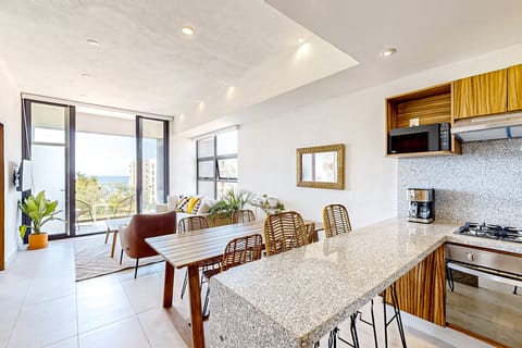 Modern glass-enclosed workspace with a large table, comfortable seating, and warm lighting—perfect for meetings, remote work, or collaborative sessions in a stylish, quiet setting.