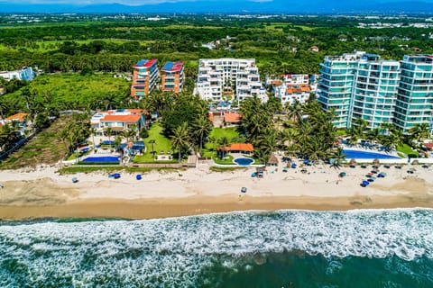 Experience luxury coastal living at a stunning beachfront resort surrounded by tropical scenery, ocean views, and direct beach access.