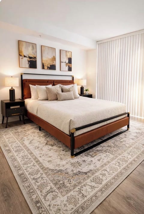 Cozy queen bedroom with plush bedding and soft neutral tones for a relaxing stay