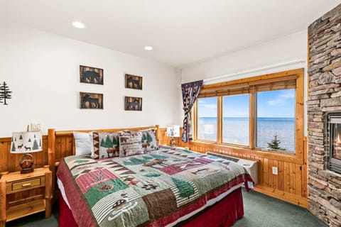 Spacious king bed studio featuring cozy comfort and breathtaking lake views right from the windows.