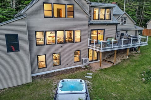 Spacious mountain retreat with private deck and hot tub, perfect for relaxing after a day of adventure.