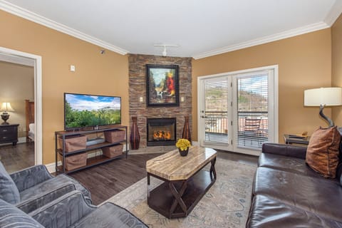 Unwind by your crackling fireplace in this elegant living room, complete with plush seating and balcony access for morning coffee moments.