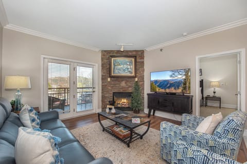 Unwind in your cozy living room where a warm fireplace and comfortable seating create the perfect retreat after mountain adventures.