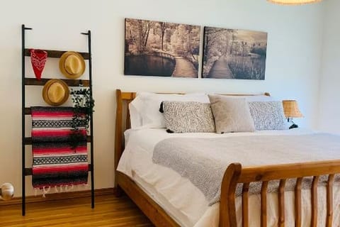 Main Floor Bedroom: a king bed + a bay window with seating pad