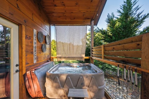 Private hot tub tucked under the covered deck for easy use anytime