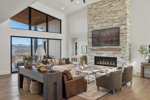 Grand living room with stone fireplace and vaulted ceilings