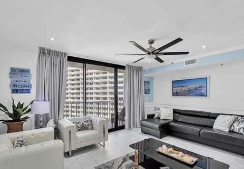 Open concept living area with stylish seating and modern furnishings that elevates your stay
