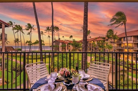 The covered lanai is set for outdoor dining with ocean views, perfect for a nightcap while watching the sunset.