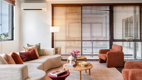 Sunlit living room with warm textures, soft furnishings and a relaxed, inviting atmosphere