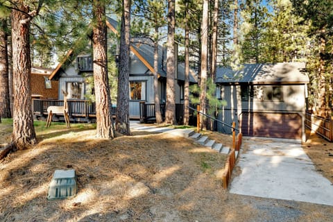 Welcoming cabin entry surrounded by towering pine trees, offering fresh mountain air and a peaceful forest setting—the perfect first impression for your Big Bear Lake getaway.