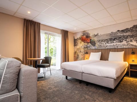 Unwind in a bright room with plush beds and garden light.