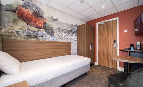 Unwind in crisp linens beneath the striking nature mural.