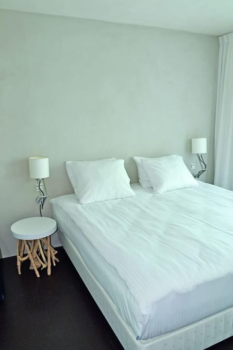 Drift off in crisp linens with minimalist, calming style.