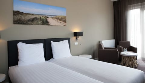 Sink into crisp twin beds after a day of exploring.