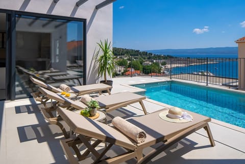 Enjoy sea views from the sun deck featuring five deck chairs by the private heated pool.