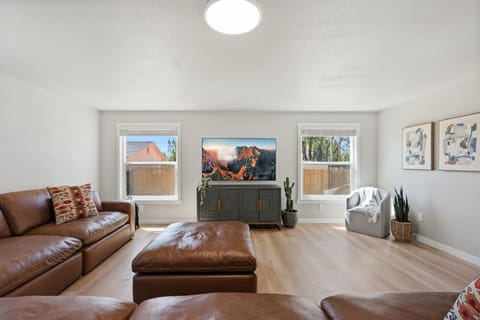 Sink into rich leather seating while your favorite shows play on the large TV. Natural light flows through twin windows, creating the perfect space for relaxation.