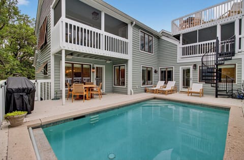 Your private pool awaits with teak loungers and outdoor dining for perfect poolside relaxation.