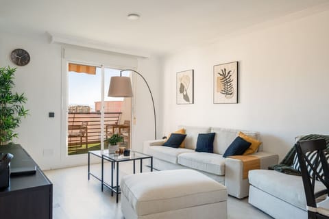 The bright living area opens directly onto a private terrace, allowing the fresh Mediterranean breeze to flow through the apartment. It`s a comfortable, light-filled space designed for relaxation after a busy day of sightseeing.