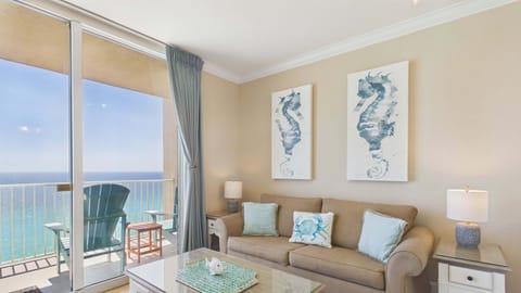 Open concept living area with comfy furnishings and sleeper sofa + balcony access (sleeps 2)