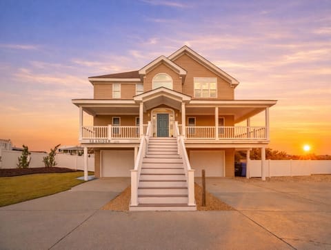 Stunning coastal home with elevated design and wraparound porches—arrive in style and start your beach vacation the moment you pull in.