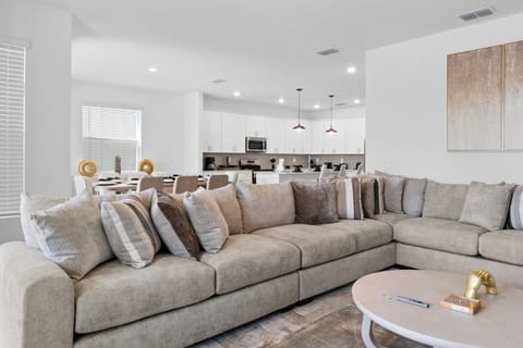 Sink into your spacious sectional sofa and enjoy the open-concept living with a fully equipped kitchen just steps away for convenient meal prep.