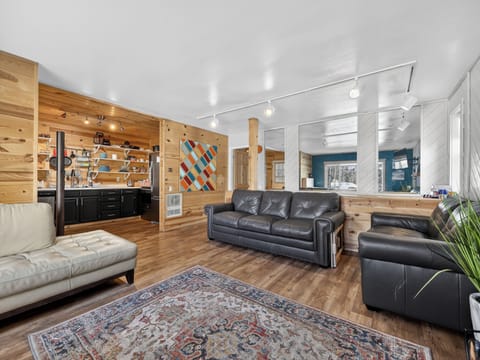 Unwind in your spacious living room with rich wood accents, leather seating, and an open kitchen perfect for home-cooked meals.