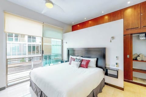 Bedroom with king-size bed and natural light.