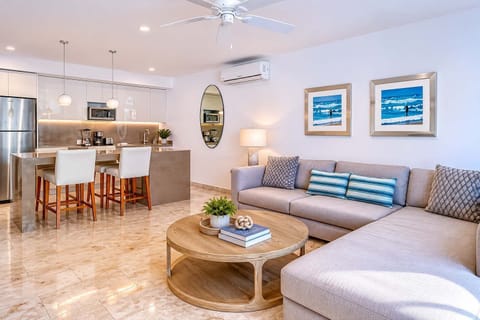 Open-concept living and dining area with sofa and smart TV