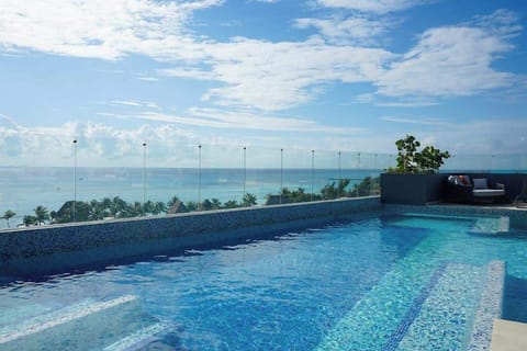Shared rooftop pool with ocean views