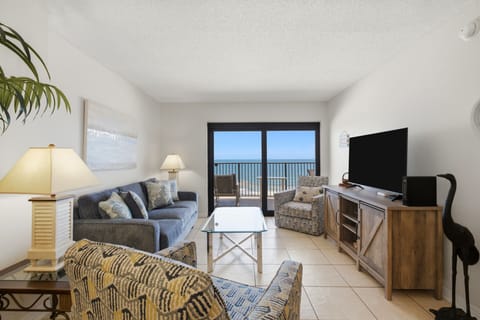 Ocean Breeze E702- Relax in your coastal living room where a comfortable sofa, stylish chairs, and modern entertainment await. Step through the balcony doors to breathe in fresh ocean air and soak in endless blue horizon views.