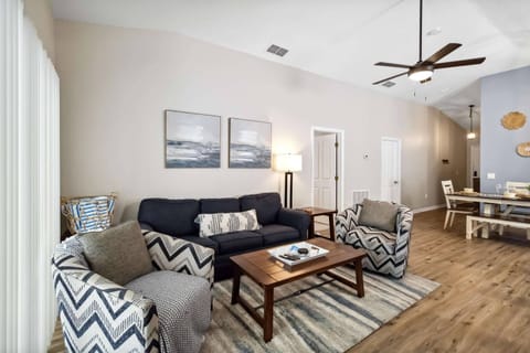 Living Room with wall mounted TV, ceiling fan and access to the private pool