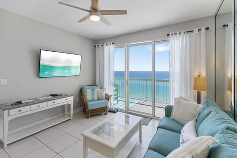 Relax in your bright oceanfront living room with stunning sea views from floor-to-ceiling windows and comfortable coastal decor.