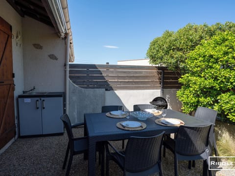 Private patio with furniture and a barbecue