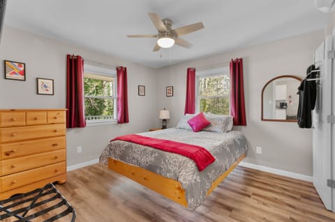 Upstairs Bedroom 1: Stylish retreat with vibrant décor and serene nature views, perfect for relaxation!