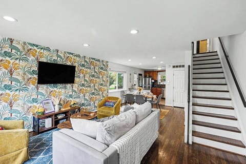 Relax in the bright and open living room, featuring a comfortable oversized sofa, and flat screen tv.