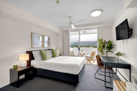 The studio bedroom features a cosy queen-size bed, workspace, and a private setting perfect for added comfort and privacy.