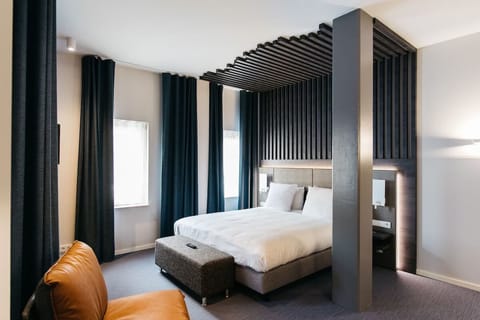Recharge in a designer room with dramatic, cozy lighting.