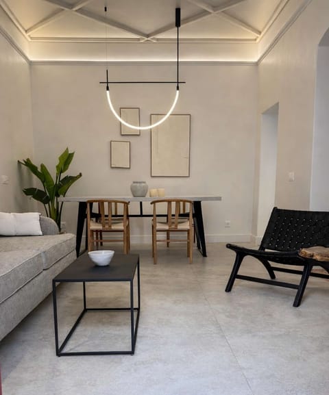 Bright, open-plan living area with dining table and stylish furnishings, designed for comfort and socializing.